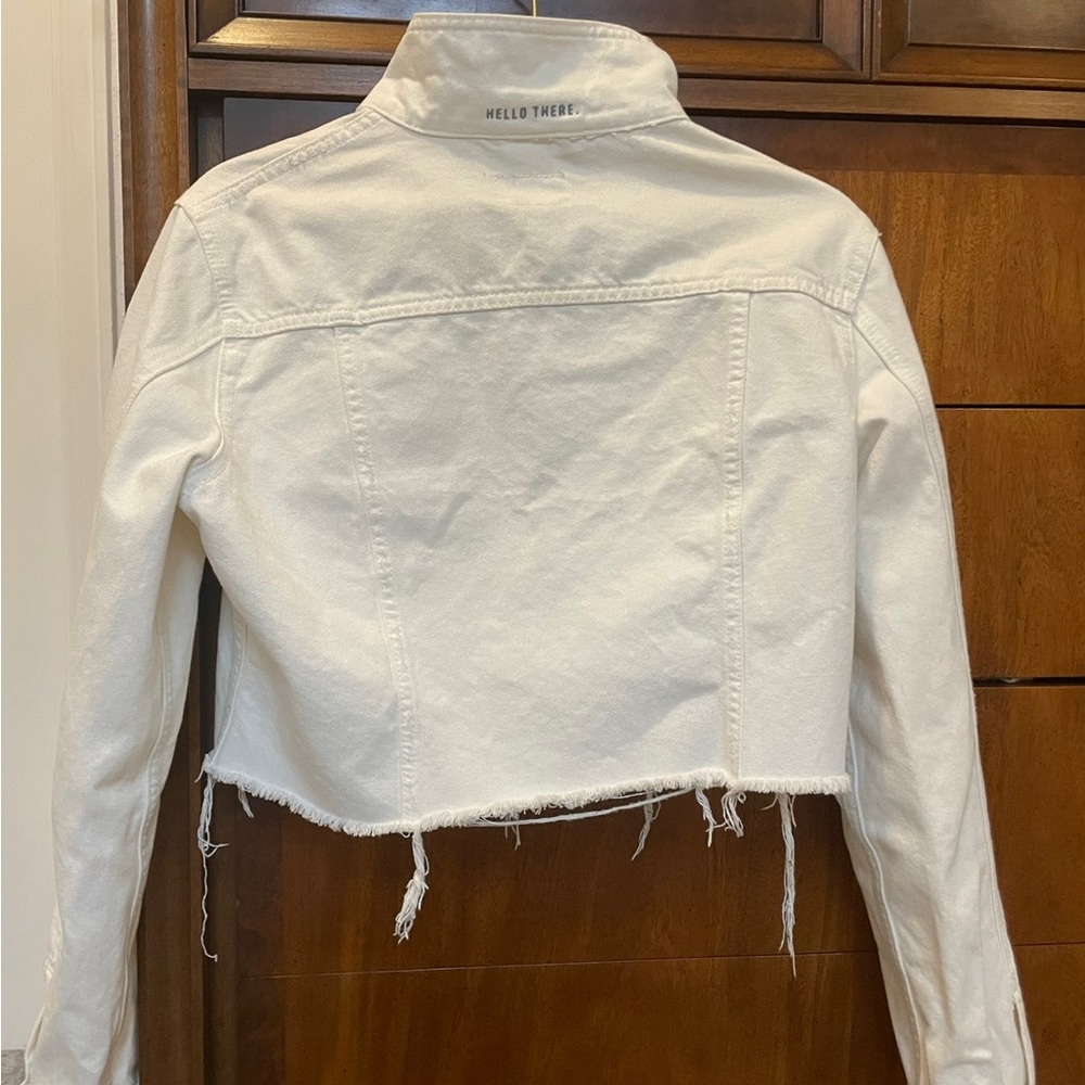 Lightweight, cropped white denim jacket with cute embroided phrase on collar